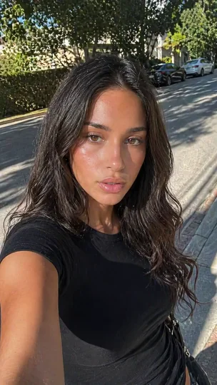 AI character filming a selfie on a street