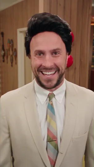 AI character in a beige suit on a retro set